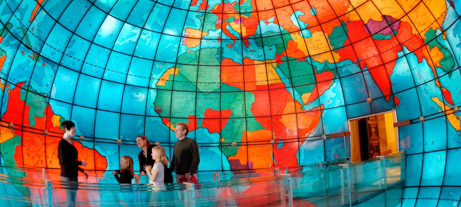 A Colorful Umbrella With Mapparium In The Background
